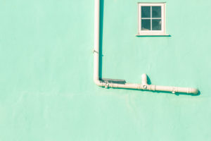 A pipe installation on the exterior wall of a house in England. A pipe installation on the exterior wall of a house in England.